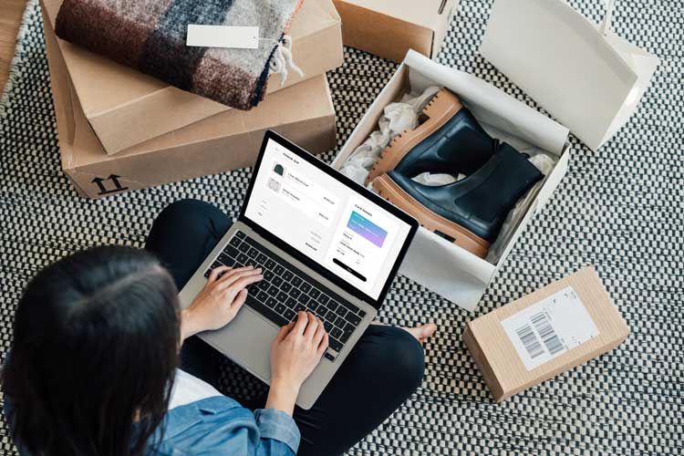 Woman sitting on laptop, shopping from home